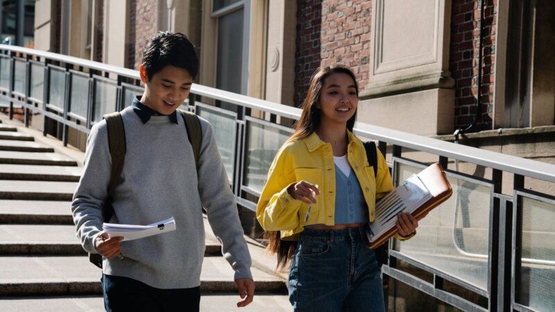 Two teenagers walking together outdoors in casual conversation