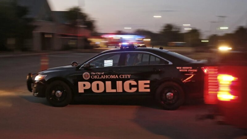 Oklahoma police patrol car with emergency lights at night