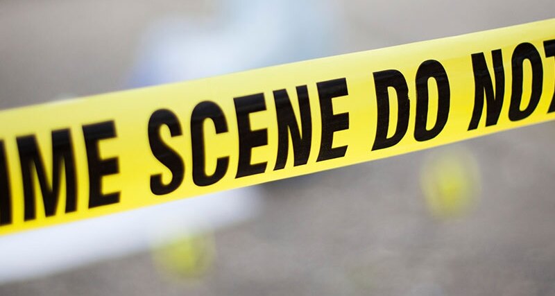 Yellow police crime scene tape at a street scene