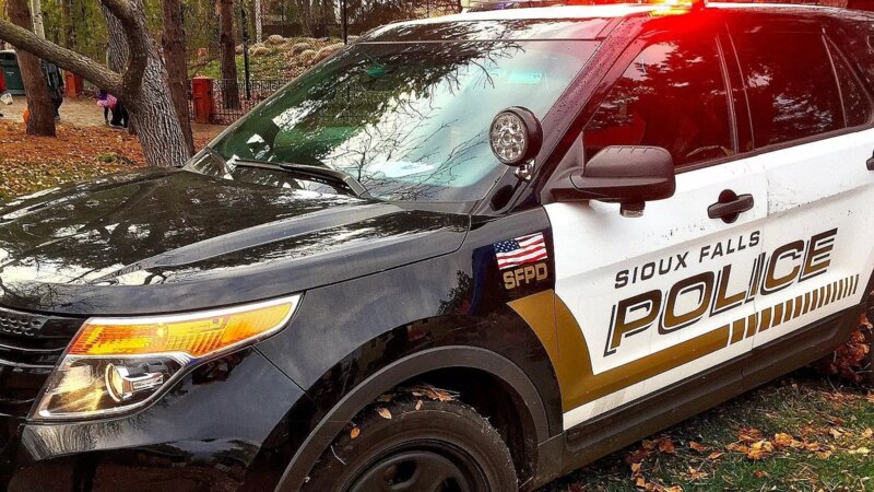 Sioux Falls police patrol car with emergency lights flashing